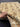 Authentic handmade ivory floral Chobi carpet 5x7 ft shown in hands – soft beige wool Persian-style carpet.