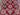 Close-up of floral pattern on red and beige wool Kazakh rug