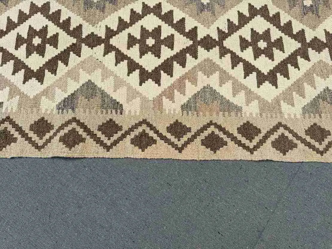 Detail of beige and brown colors in handmade kilim rug