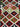 Close-up of geometric pattern on handmade Kilim runner rug in red and green