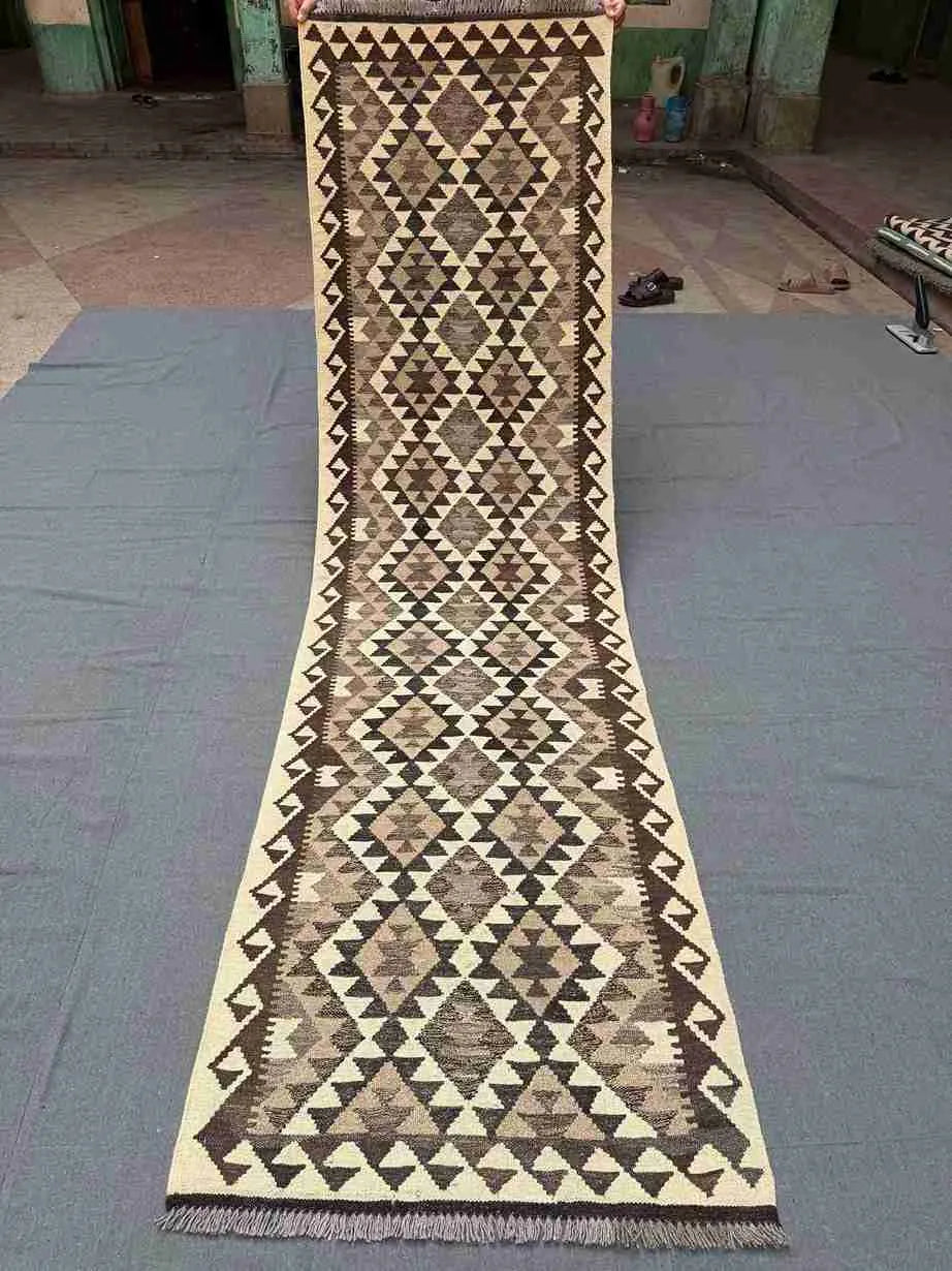 Full view of 2x9 flatweave Kilim runner rug in neutral colors