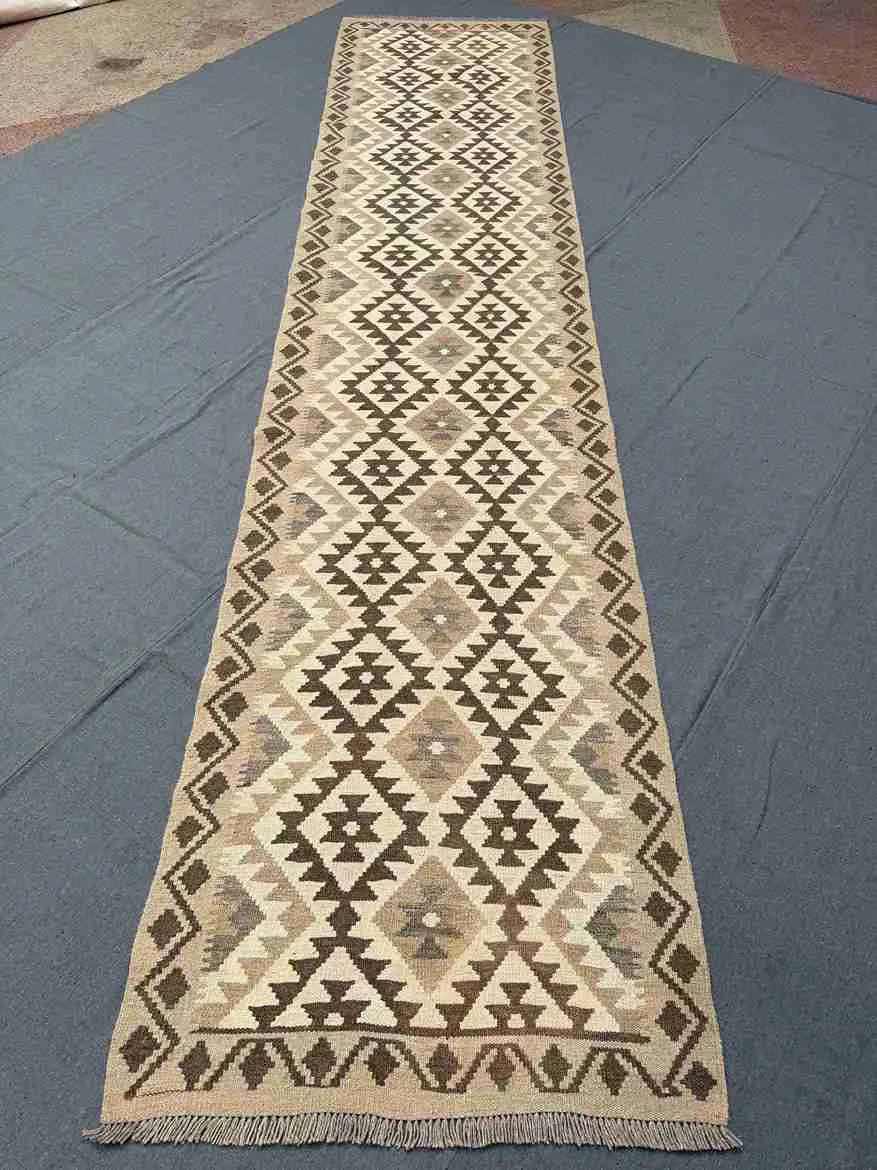 Beige and brown kilim runner rug placed in hallway
