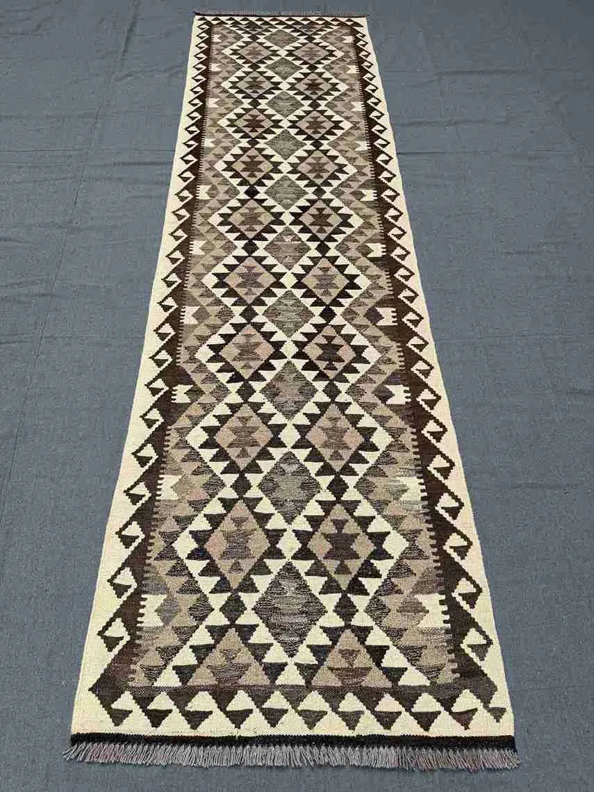 Flatweave Kilim runner on rustic hallway floor – boho décor