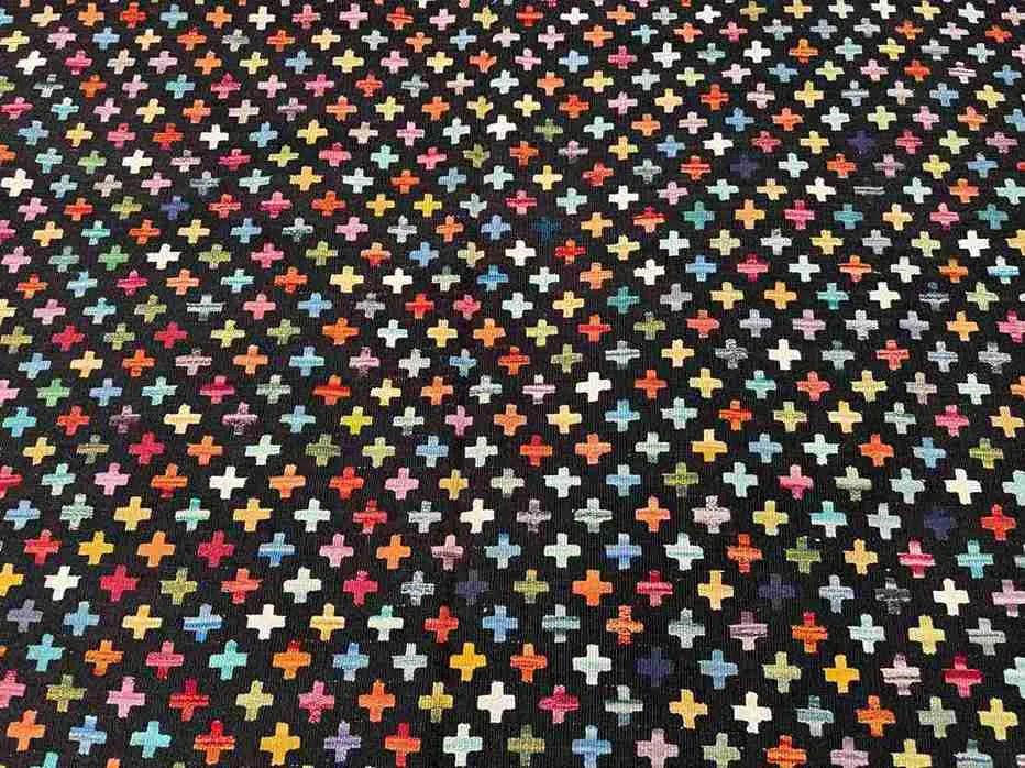 Detail of knotted design on colorful Turkish Kilim rug – bright tones with boho pattern.