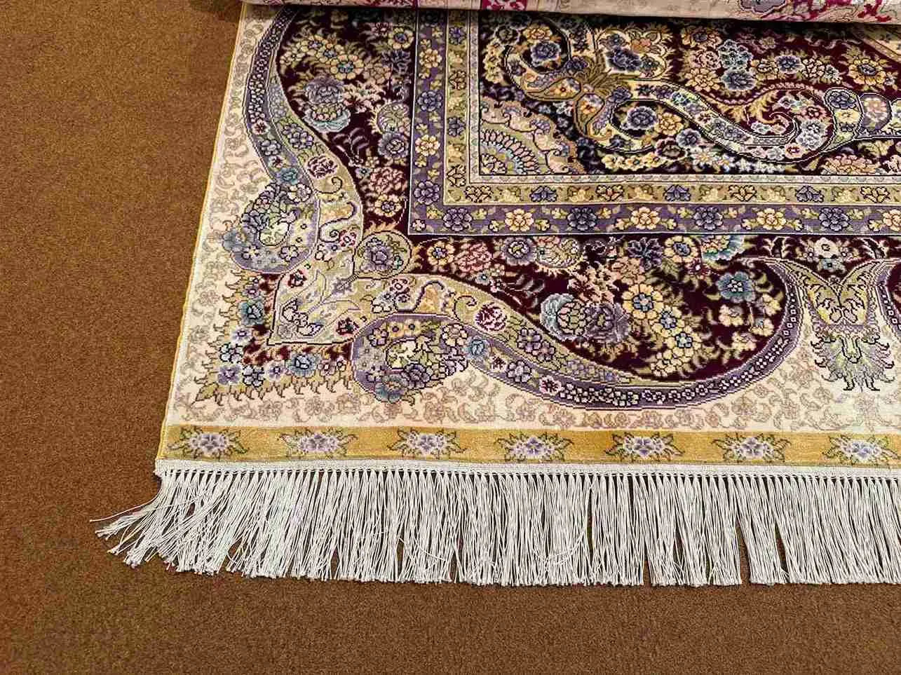 Corner detail of 5x8 knotted Persian-style handmade silk rug
