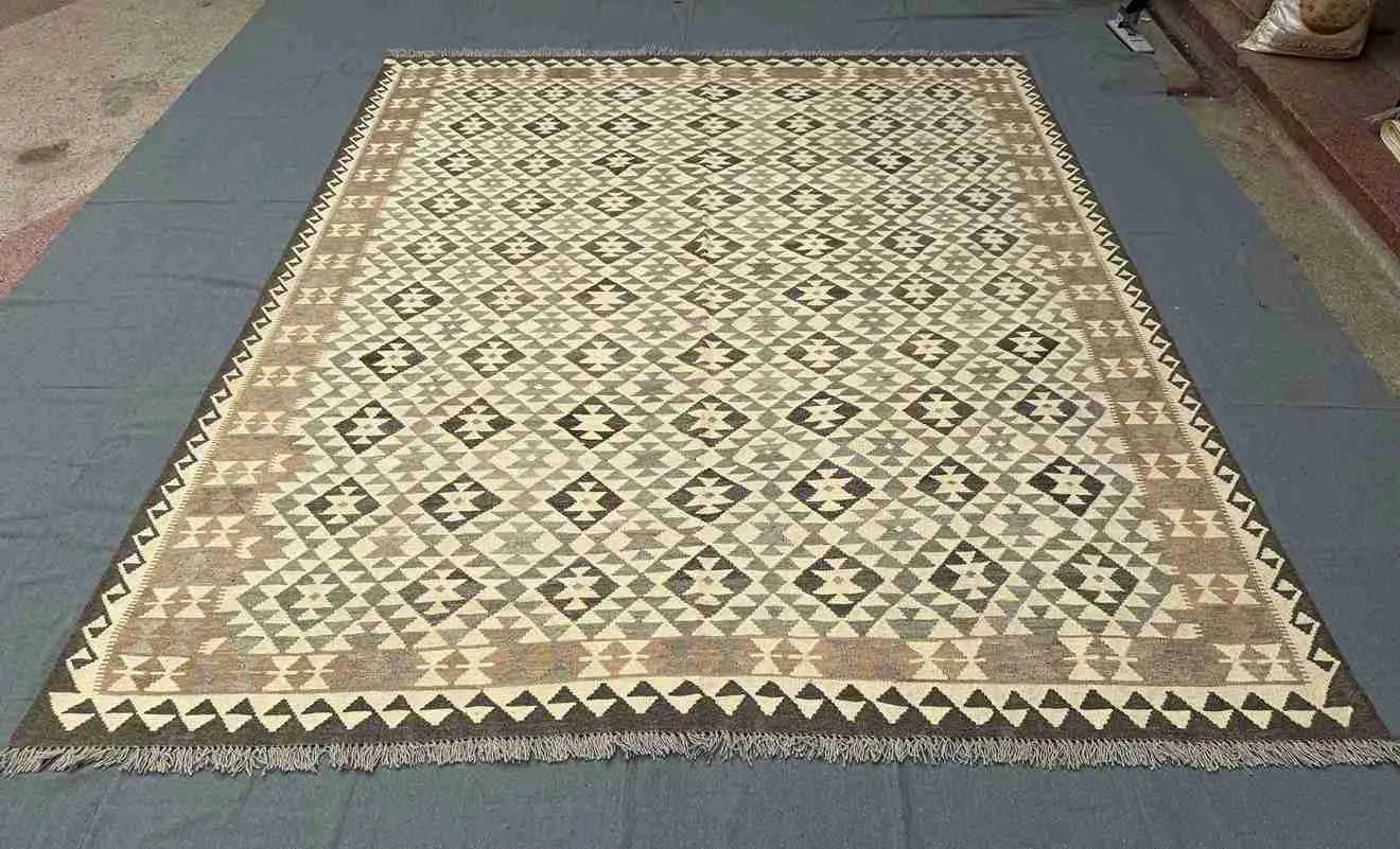 Large 8x10 Kilim rug placed in modern rustic interior – traditional wool flatweave.