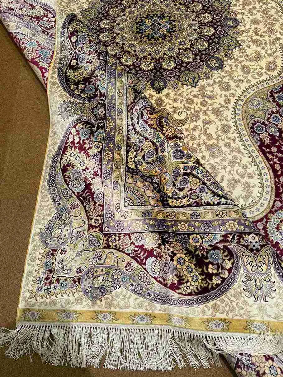 Folded handmade silk rug displaying texture and quality