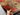 Handmade 5x7 red and blue Mamluk rug held by hands – front view