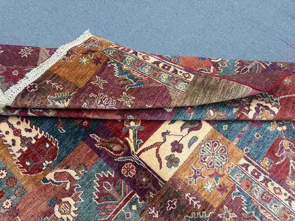 Folded edge and texture detail of colorful Persian-style patchwork rug