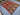 Angle view of red handmade Kilim rug on living room floor