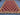 Red 5x7 kilim rug placed on floor in living room – tribal wool decor