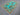 Side angle of turquoise Tree of Life wool rug on floor