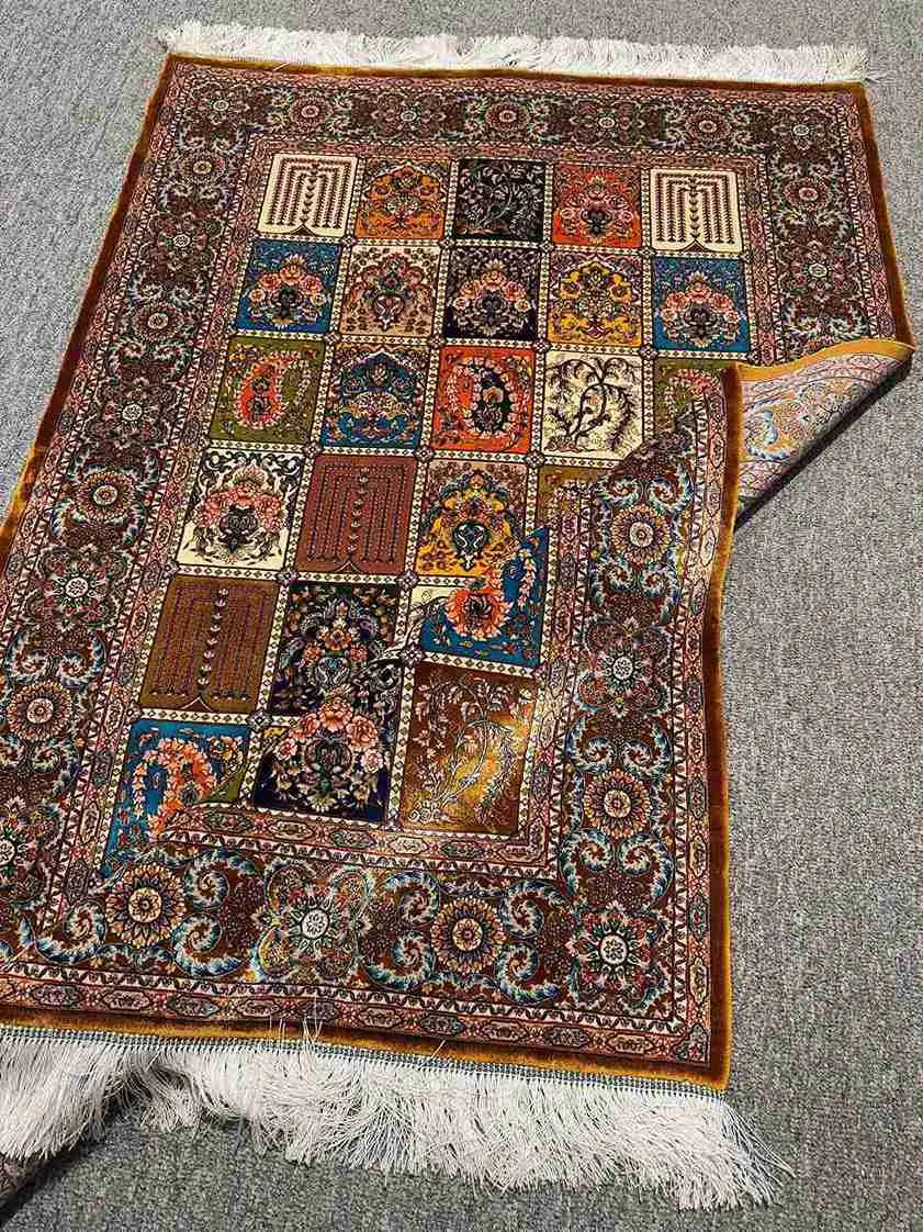 Folded silk patchwork rug showing underside weave