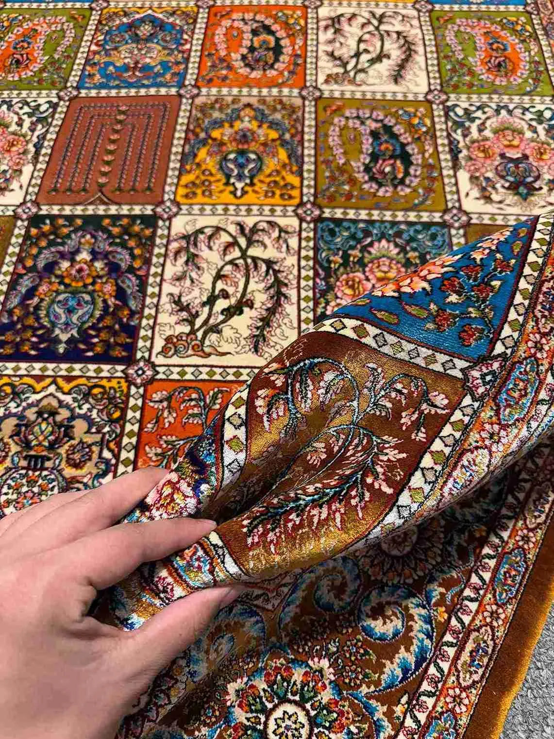 Artisan Silk Patchwork Rug held in hands – soft texture detail