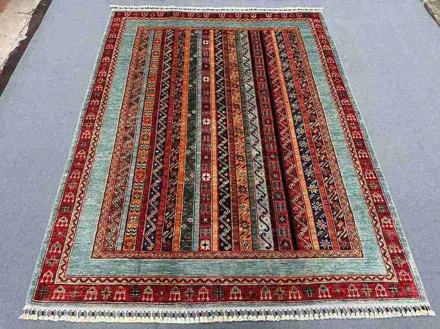 Floral and striped Turkish rug on floor in oriental living room