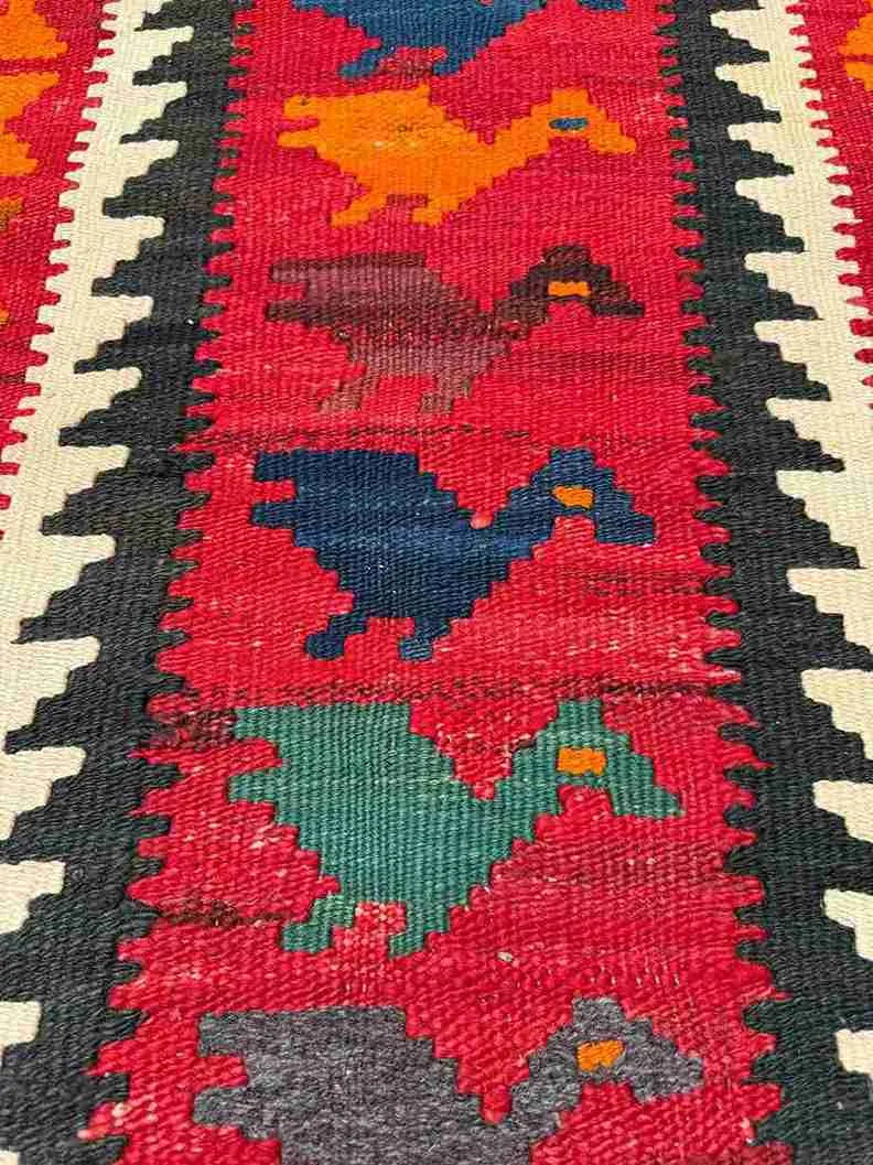 Close-up of wool flatweave texture on multicolor Turkish Kilim – knotted and handcrafted.