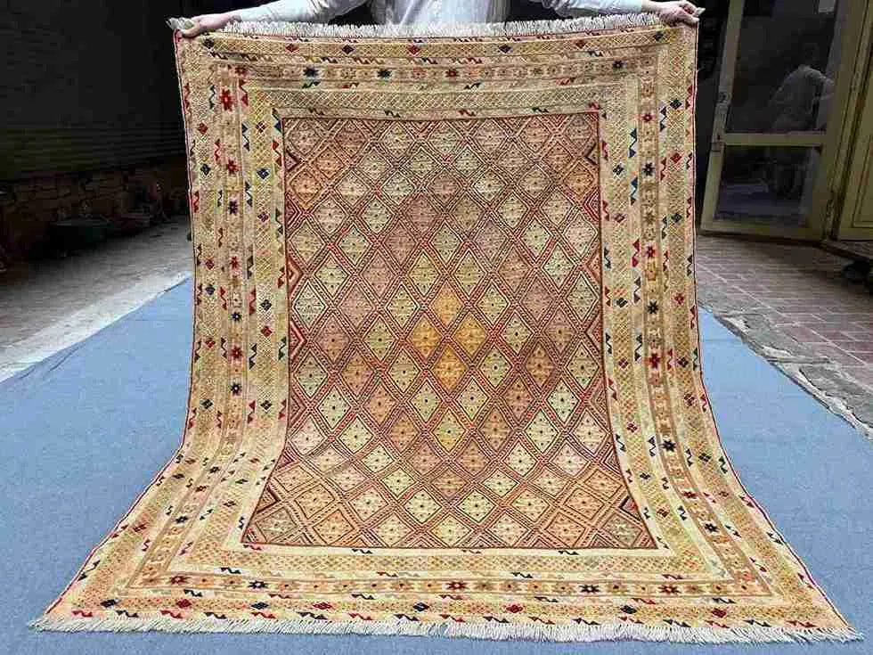 Full top-down view of handwoven 5x6.2 Afghan Turkish rug with beige, gold & brown tribal geometric design