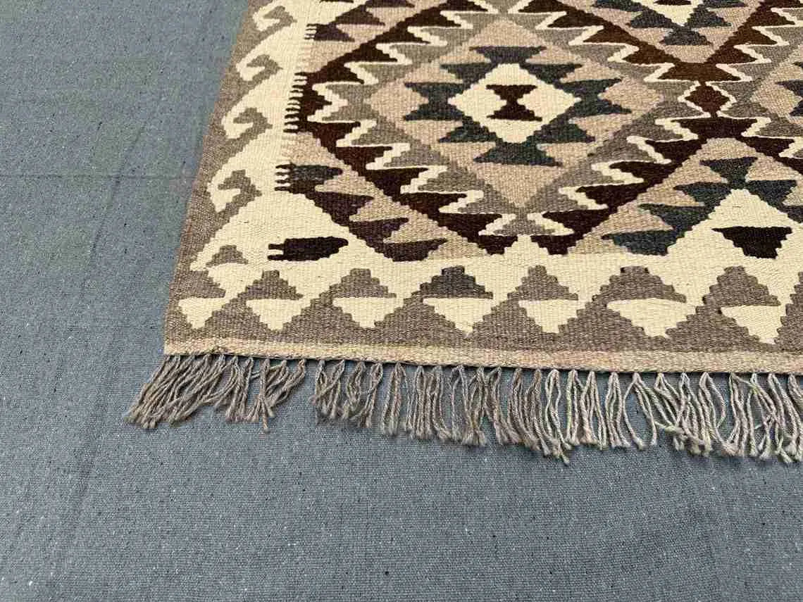 Corner weave close-up of tribal Turkish Kilim rug – handmade wool flatweave with knotted texture.