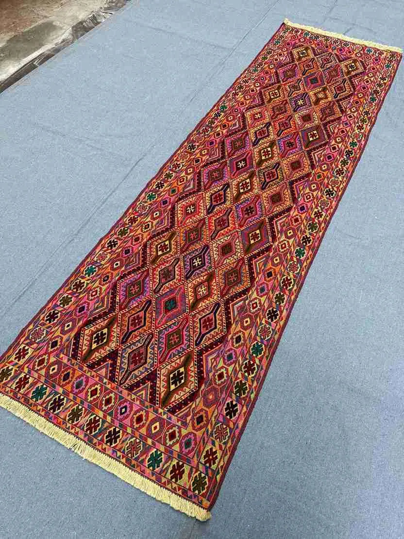 Side angle of vintage wool kilim rug placed in entryway