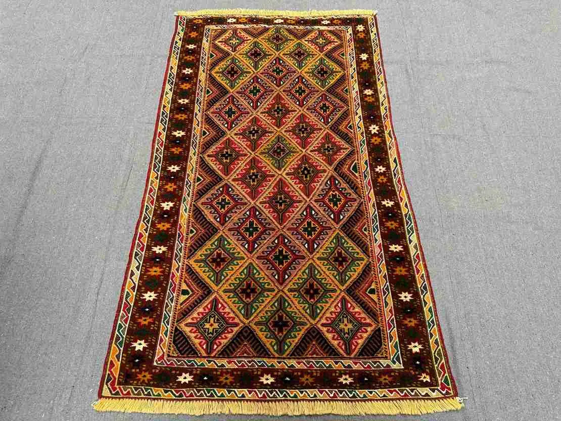 Floor view of tribal Afghan kilim runner rug placed in narrow space