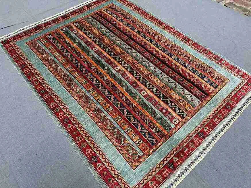 Handwoven wool Turkish area rug styled in bohemian home interior