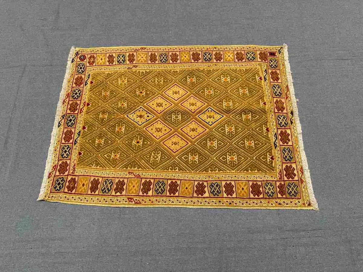 Vintage flatweave wool kilim rug styled on modern home floor
