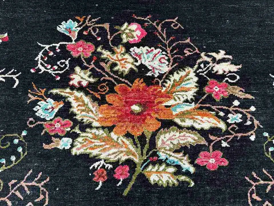 Close-up of vintage floral design on black handmade Karabakh rug