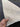 Handmade 15ft Oushak runner rug held to show authentic wool texture