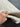 Soft pink and blue Turkish hallway rug held for close detail view