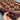Handmade 3x4 red and cream tribal rug held in hand showing wool texture