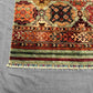 Corner detail of 5x7 tribal wool carpet – vibrant bohemian design
