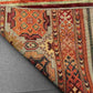 Folded backside of knotted tribal rug – wool and silk texture detail
