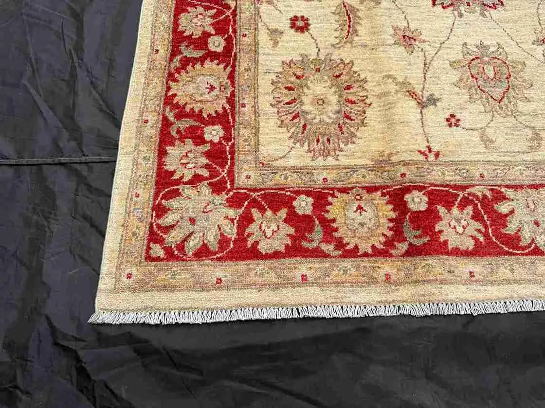 Detailed corner view of hand-knotted red and cream Persian rug