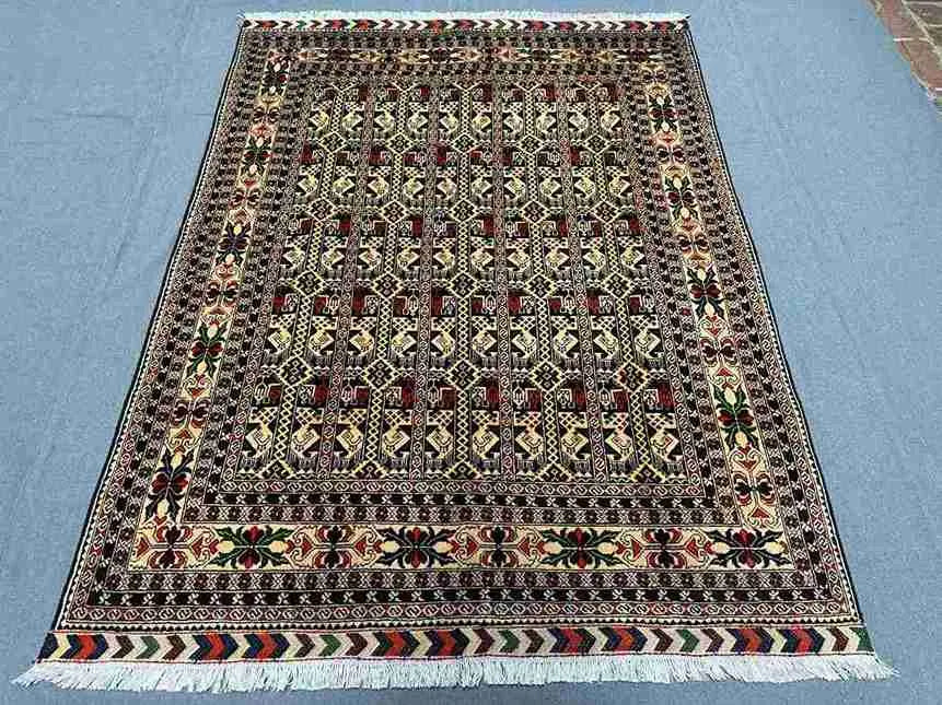 5x7 Persian-style Oriental rug displayed on floor – red and floral patterns