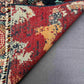 Corner fold showing backside and knot density of handmade 5x7 rug