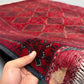 Handmade 5x8 red Afghan-style wool rug held in hands