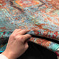Front view of 5x8 multicolor Mamluk rug held by hand