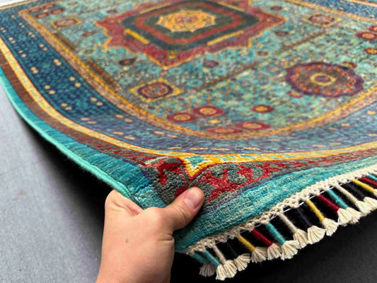 Handmade 5x8 modern Turkish Mamluk rug shown in hand