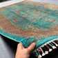 6x8 handmade Mamluk rug in hand showing vibrant green and orange wool texture