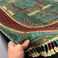 Handmade 6x8 red and teal Mamluk rug shown in-hand for detail