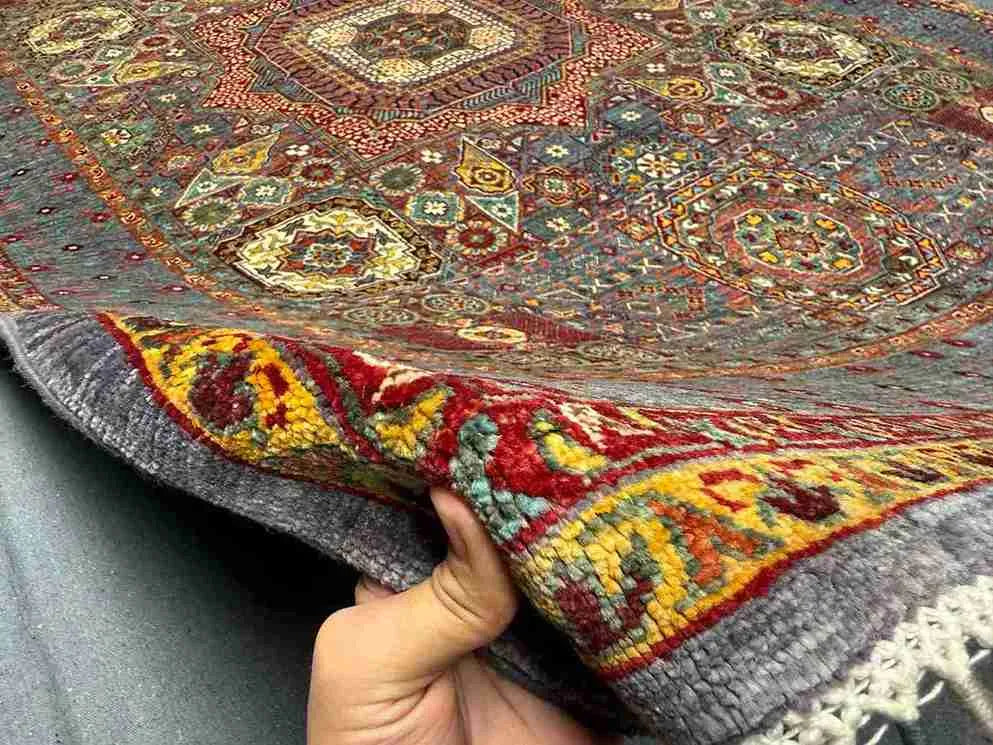6x8 handmade Turkish Mamluk rug shown in hands – wool silk knotted oriental design