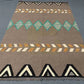 Brown and turquoise Kilim rug styled in hallway decor.