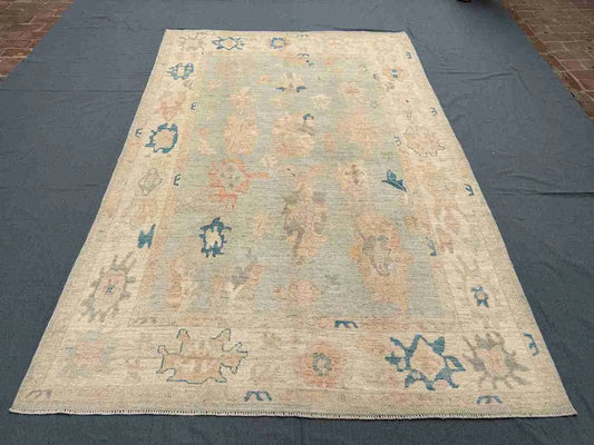 6x9 handmade Turkish Oushak rug displayed on wooden floor