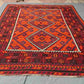 8x12 handwoven Kilim rug with geometric red and black pattern – Turkish tribal carpet on floor.