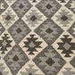Close-up of earthy toned Kilim runner rug weave texture