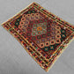 Flatweave Afghan rug in vintage interior with red and multicolor tones