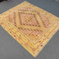Soft pastel Afghan kilim rug styled on floor with boho decor