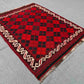 Small vintage Afghan Kilim rug displayed on floor – red wool flatweave for rustic or boho decor.