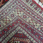 Afghan wool silk rug folded to show quality of hand-knotted craftsmanship