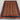 Afghan wool shawl rug laid out on floor – striped tribal area rug in boho setting.